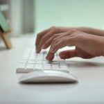 person typing on computer keyboard